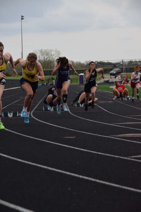 Junior Marisa Sanchez explodes of the blocks in the 200m. 