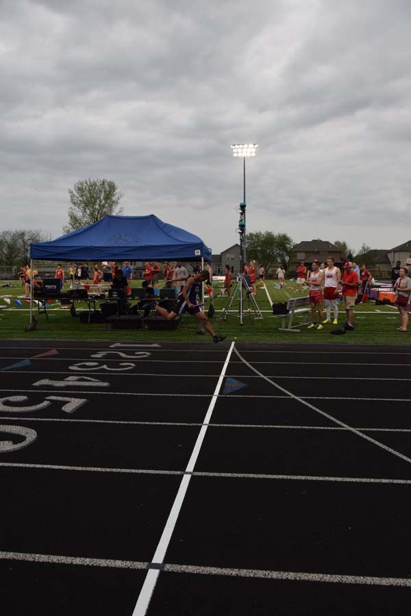 Sophomore David Holmes crosses the finish line, getting first place for the 4x4. 