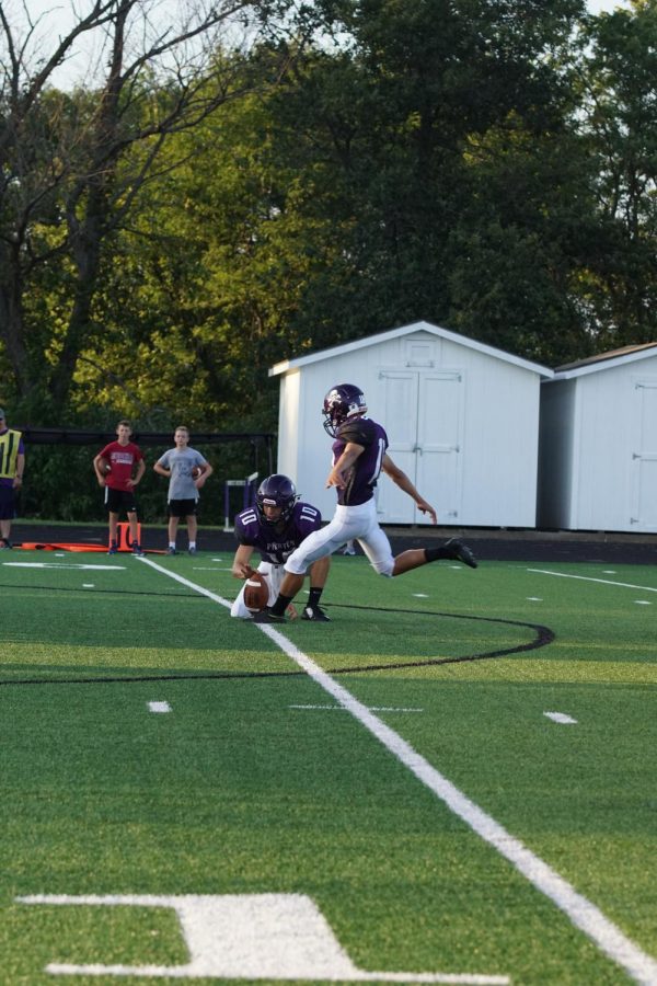 Senior Johnny Moon kicks a field goal to get an extra point after a touchdown. 