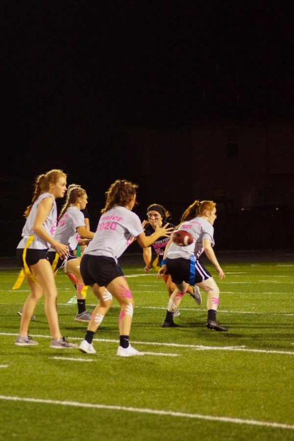 Junior quarterback Grace Banes catches the snap and gets ready to hand off the ball to sophomore Kinley Brown. 
