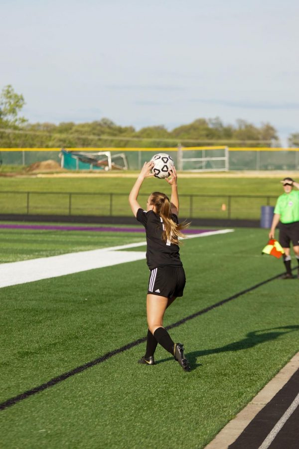 Sophomore Emma Hawley throws in the ball at the Varsity Soccer game on May 3 at Piper High School. The Pirates fell short tothe Lady Broncos, the score being 2-0. 