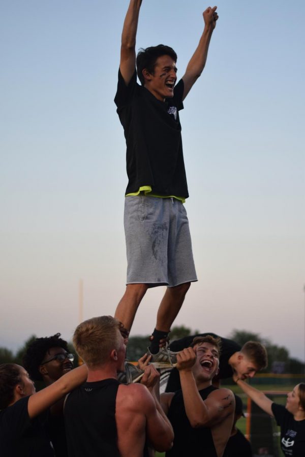 Senior Abraham Marquez and his base practices stunts before the Powderpuff game on Sept 18 at Piper High School.